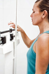 Woman on a scale checking weight