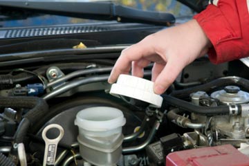 Locate the brake fluid reservoir and unscrew the cap.