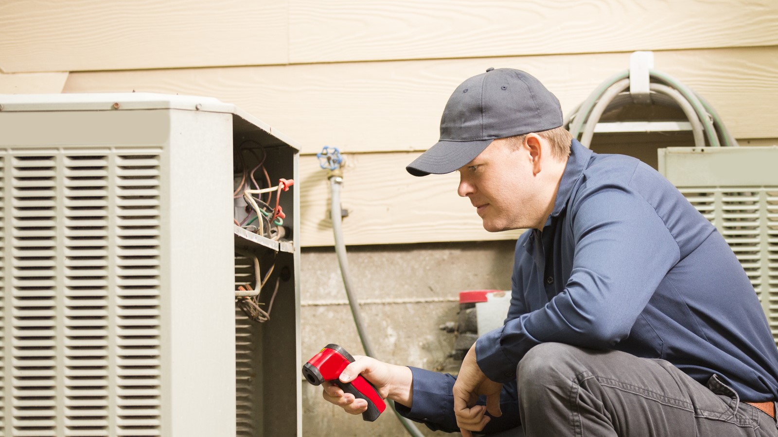 a man fixing the AC unit