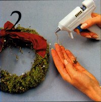 In step 2, glue the end of the folded wire to the top of the wreath.
