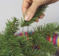 Insert sprigs of evergreen in an arc across the top of the wreath.