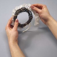 Overlap the ends of the eyelet onto the Christmas wreath ornament.