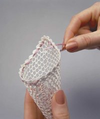 Weave ribbon into cone to create Victorian ornament.