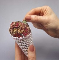 Insert flowers into cone to make Victorian ornament.