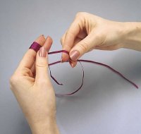 Wrap the ribbon around your fingers to create a loopy bow.