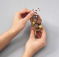 Glue candy canes into sleigh for ornament.