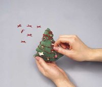 Sew the ornaments to the tree in a symmetrical pattern.