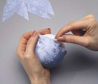 Distribute the pieces of fabric evenly around the foam ball.