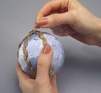 Cover the seams on the ornament with the gold ribbon.