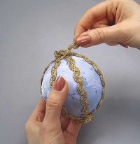 Glue a circle of gold ribbon at the top and bottom of the ornament to cover the exposed ends.