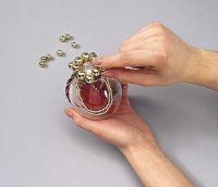 Glue the smaller balls to the ornament to fill the blank spaces.