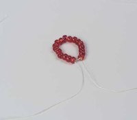 Once you have strung 18 beads, form a circle and tie it off.