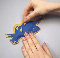 Glue the triangles to the ornament in a random pattern.