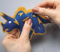 Draw the gold needle through the ornament to make a hanger.
