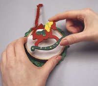 To finish the Noel Rocking Horse ornament, glue the horse to the muslin.