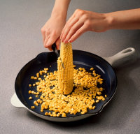 Stand the cob on end and cut down the sides, releasing the kernels.