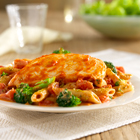 Chicken breasts, simmered in tomato sauce, served with pasta and broccoli tossed with a creamy tomato-pesto sauce Chicken breasts, simmered in tomato sauce, served with pasta and broccoli tossed with a creamy tomato-pesto sauce
